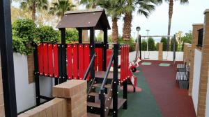 a playground with red dividers in a park at Vistasmar Primera Linea in Oropesa del Mar