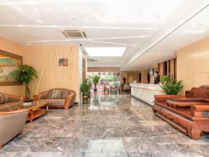a lobby with couches and chairs in a building at Zmax Hotel Guangzhou Railway Station in Guangzhou