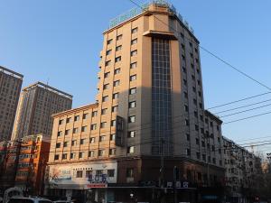 a tall building with a crane on top of it at Xana Hotelle Shenyang Zhongshan Plaza the Affiliated First Hospital of China Medical University in Shenyang