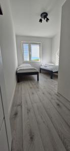 Ένα ή περισσότερα κρεβάτια σε δωμάτιο στο Apartament Mrągowo 3 jeziora