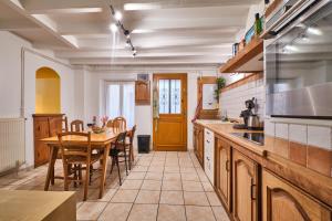 a kitchen with a table and a dining room at Au 81 - Maison De Ville à Louer in Moirans +16 photos