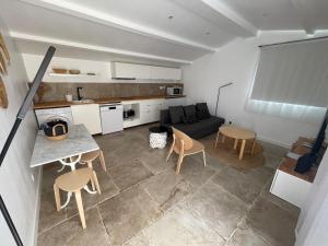 a living room with a couch and a table and chairs at Maisonnette Aix en Provence in Aix-en-Provence