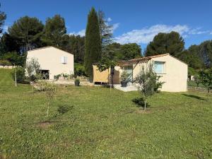 a house in a field with trees in the background at Maisonnette Aix en Provence in Aix-en-Provence