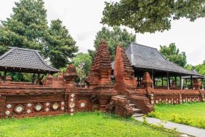 a large wooden building with a pavilion in a park at OYO Living 1877 Side Corner in Kanggraksan