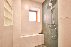 a bathroom with a shower with a glass door at Au 81 - Maison De Ville à Louer in Moirans