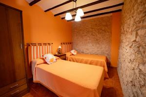Postel nebo postele na pokoji v ubytování Apartamentos rurales La Alquería del Pilar