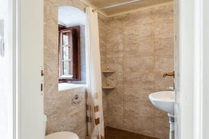 a bathroom with a toilet and a sink at Casa tradizionale Goulas in Monemvasia +21 photos