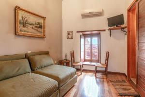 a living room with a couch and a window at Casa tradizionale Goulas in Monemvasia