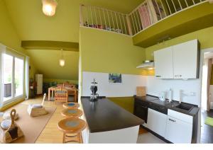 a kitchen with a counter and some chairs in it at Ferienwohnung Vilzsee in Mirow