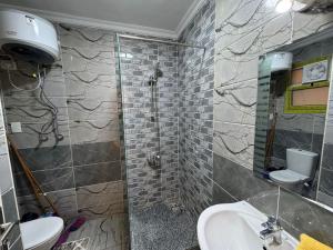 a bathroom with a shower and a sink and a toilet at CK_212 . Spacious 2BR Apt. 2 Baths in Sheikh Zayed +8 photos