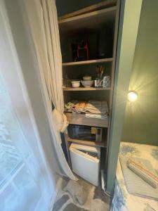 a room with a closet with a bed and a curtain at Casquets - Chambre randonneur GR223 - Quai des Ormes in Barneville-Carteret +6 photos