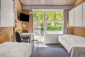 Postel nebo postele na pokoji v ubytování Flinten Horsens + 35 fotografií