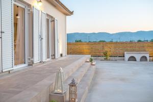 a patio with a bench and a fence at Villa Du Vignoble in Zakynthos Town