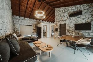 a living room with a couch and a table at Ktima Papadopoulou in Krionérion