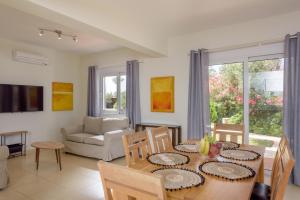 a living room with a table and chairs and a couch at Aloni Grove Retreat in Chania