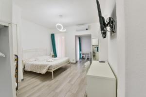 a white bedroom with a bed and a mirror at VILLA IRMA in Varigotti +17 photos