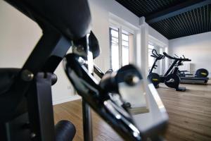 a gym with two exercise bikes in a room at Laguna Beskidów Resort - Apartament A28 Premium in Zarzecze +11 photos
