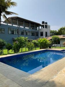 a swimming pool in front of a building at Premelthi Homestay bed and breakfast Mount Lavinia in Watumulla +18 photos