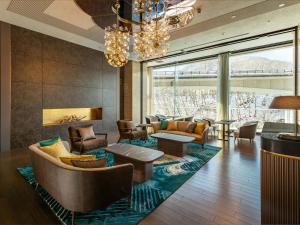 a living room with couches and chairs and a chandelier at Executive Suite SUIREI in Jozankei +60 photos