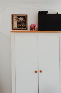 a white cabinet with a television on top of it at Holiday Home Casa Rondo in Bihać