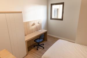 a bedroom with a desk and a bed and a mirror at E16 - Estudio La Orotava in La Orotava