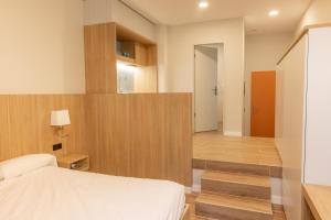 a bedroom with a bed and a stairway with a room at E16 - Estudio La Orotava in La Orotava