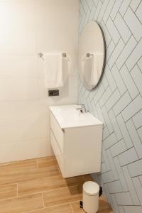 a white bathroom with a sink and a mirror at E16 - Estudio La Orotava in La Orotava