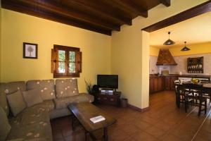 a living room with a couch and a table at Fontanales Pelibuey by Villas Rivero in Moya