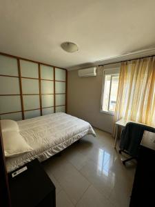 Ένα ή περισσότερα κρεβάτια σε δωμάτιο στο Velo de Flor Jerez Apartment +5 φωτογραφίες