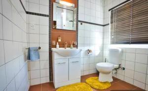 a bathroom with a toilet and a sink and a mirror at Coastal Soul no 1 in Swakopmund +36 photos