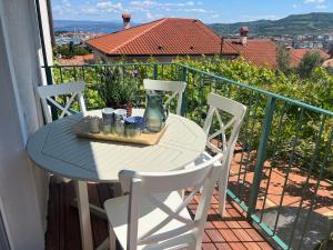 a table and chairs on a balcony with a view at Villa Maris Izola in Izola