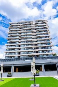 a large building with two umbrellas in front of it at Greenland Premium Apartments in Kigali