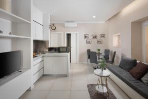 a living room with a couch and a kitchen at Luxury 4 star apartment in the Old Town Zadar in Zadar