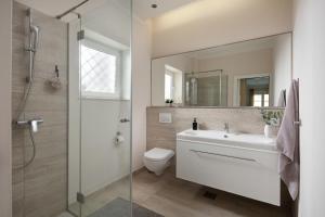 a bathroom with a sink and a toilet and a shower at Luxury 4 star apartment in the Old Town Zadar in Zadar +7 photos