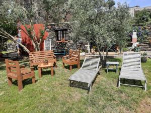 a group of benches and tables in the grass at Casa Rural Sanjora in Valverde