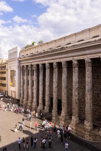 a group of people standing in front of a building at Spiriti Home Apartment , New Opening Piazza di Pietra in Rome