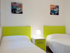 two beds in a room with two pictures on the wall at Vista Bella in Torrevieja