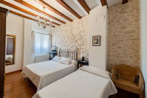 Postel nebo postele na pokoji v ubytování Apartamentos rurales La Alquería del Pilar