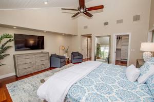 a bedroom with a large bed and a flat screen tv at Perfect Match on Baywood Lane in Wesley Chapel +43 photos