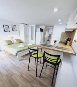 a bedroom with a bed and a table and chairs at Studio Jadro in Selce