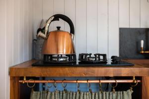 a tea kettle sitting on top of a stove at The Hyde in Cuckfield +20 photos