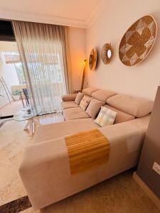 a large couch in a room with a large window at La Cabaña Roda Golf Sol in Roda +28 photos