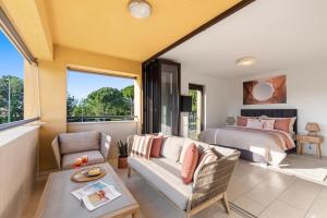 a bedroom with a bed and a living room with a couch at GRAND CENTRAL apartment with 3 bedrooms in Porec! in Poreč