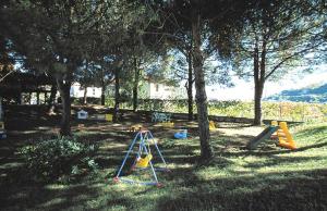 a park with a playground with trees and slides at Residence i Morelli in Pietra Ligure