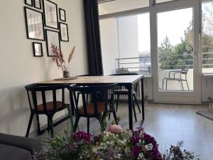 a dining room with a table and chairs and a window at Apartment Sünnanbeter mit Pool für 2-4 Personen in Dahme
