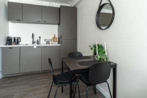 a kitchen and dining room with a table and chairs at Modern Stay with Wi-Fi - Tilburg in Tilburg