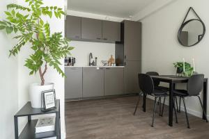a kitchen and dining room with a table and chairs at Modern Stay with Wi-Fi - Tilburg in Tilburg +36 photos