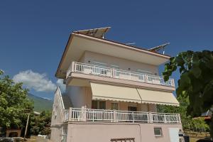 a building with white balconies and stairs on it at Zeusplace Jasmine House in Leptokaria