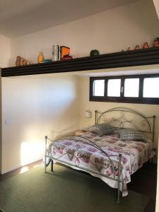 1 dormitorio con 1 cama con un estante en la pared en Panoramic Loft Artimino Tuscany, en Artimino