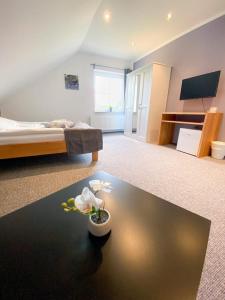 a bedroom with a bed and a table with flowers on it at Roschi's Gästehaus in Gudow